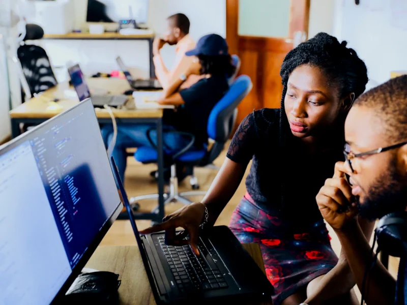 Customer service agent monitoring an AI chatbot conversation on a laptop