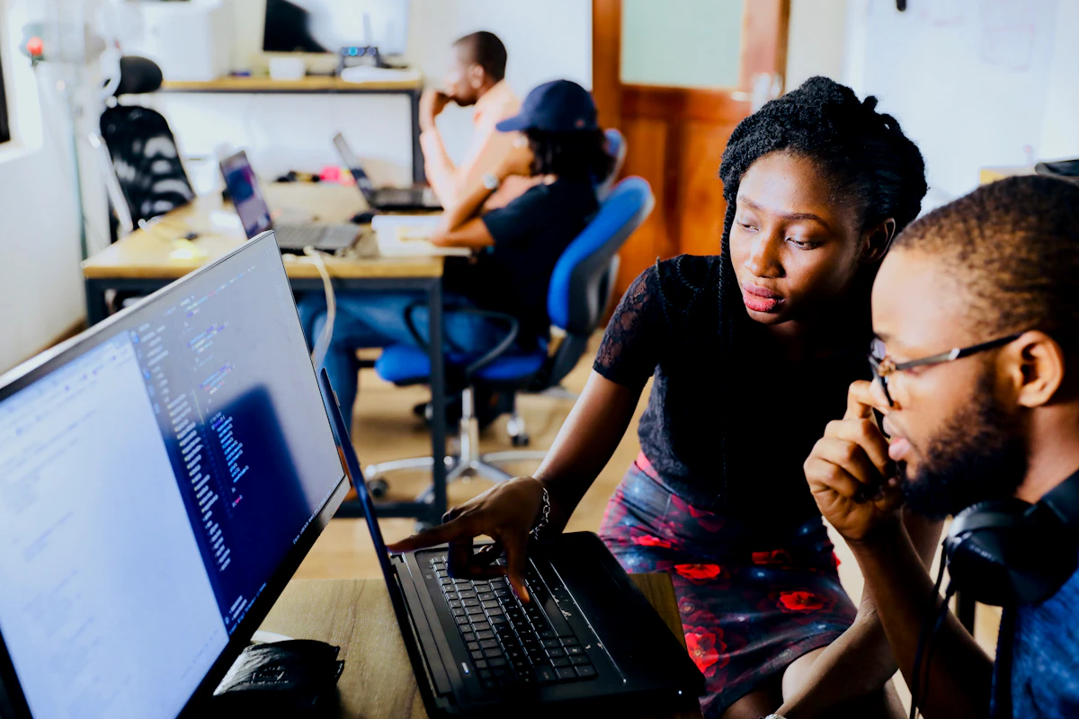 Customer service agent monitoring an AI chatbot conversation on a laptop