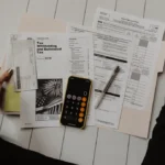 Freelancer creating an invoice on a laptop at a home desk