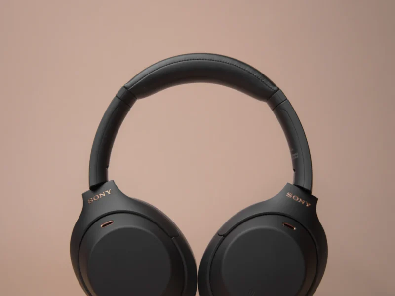 Person wearing noise-cancelling headphones while working remotely on a laptop