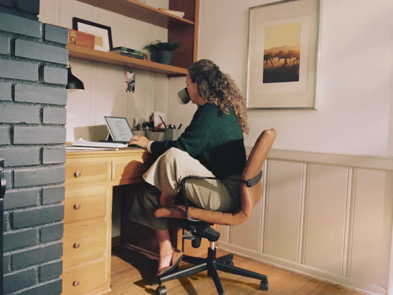 Remote worker using a laptop at a home office desk