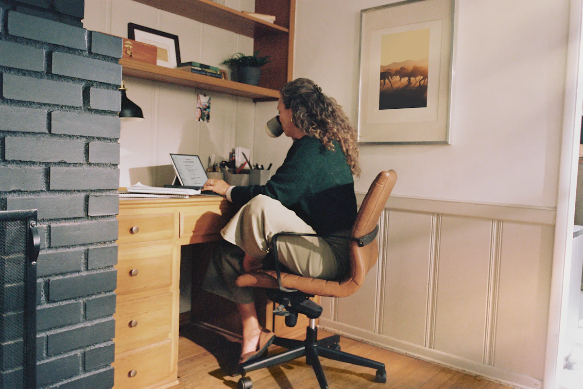 Remote worker using a laptop at a home office desk