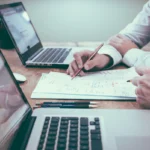 Marketer writing customer research notes to build buyer personas