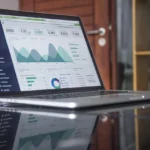 Marketer reviewing social media analytics dashboard on a laptop