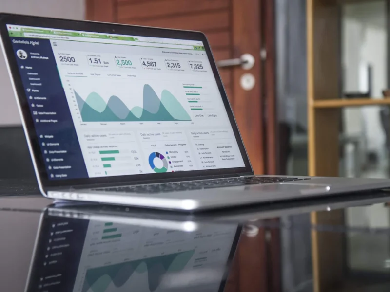 Marketer reviewing social media analytics dashboard on a laptop