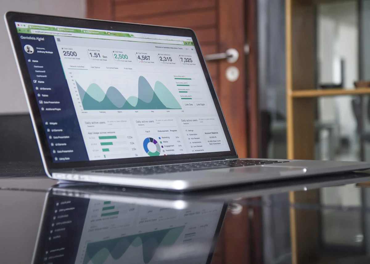 Marketer reviewing social media analytics dashboard on a laptop